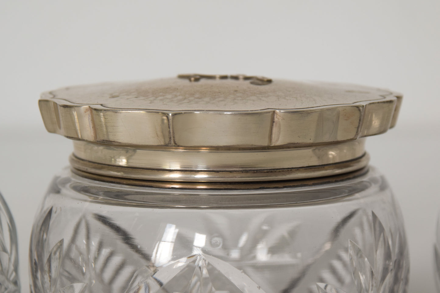 Three Silver Topped Cut Glass Bottles
