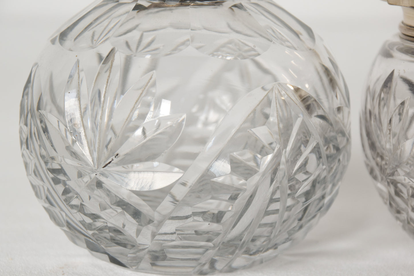Three Silver Topped Cut Glass Bottles