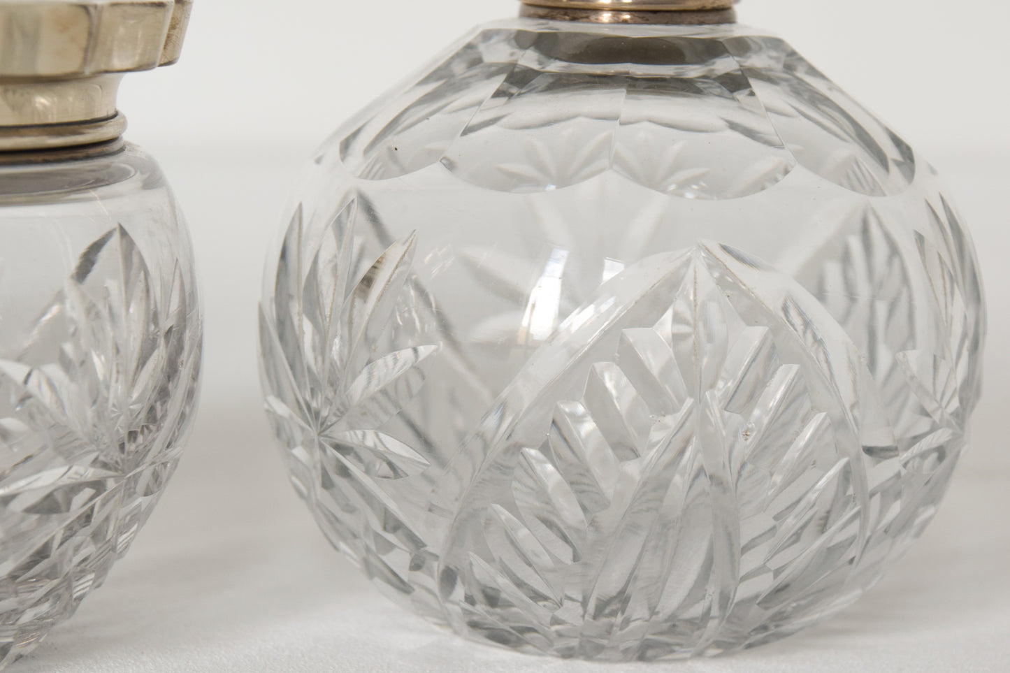 Three Silver Topped Cut Glass Bottles
