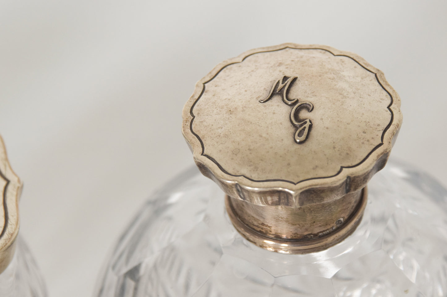 Three Silver Topped Cut Glass Bottles