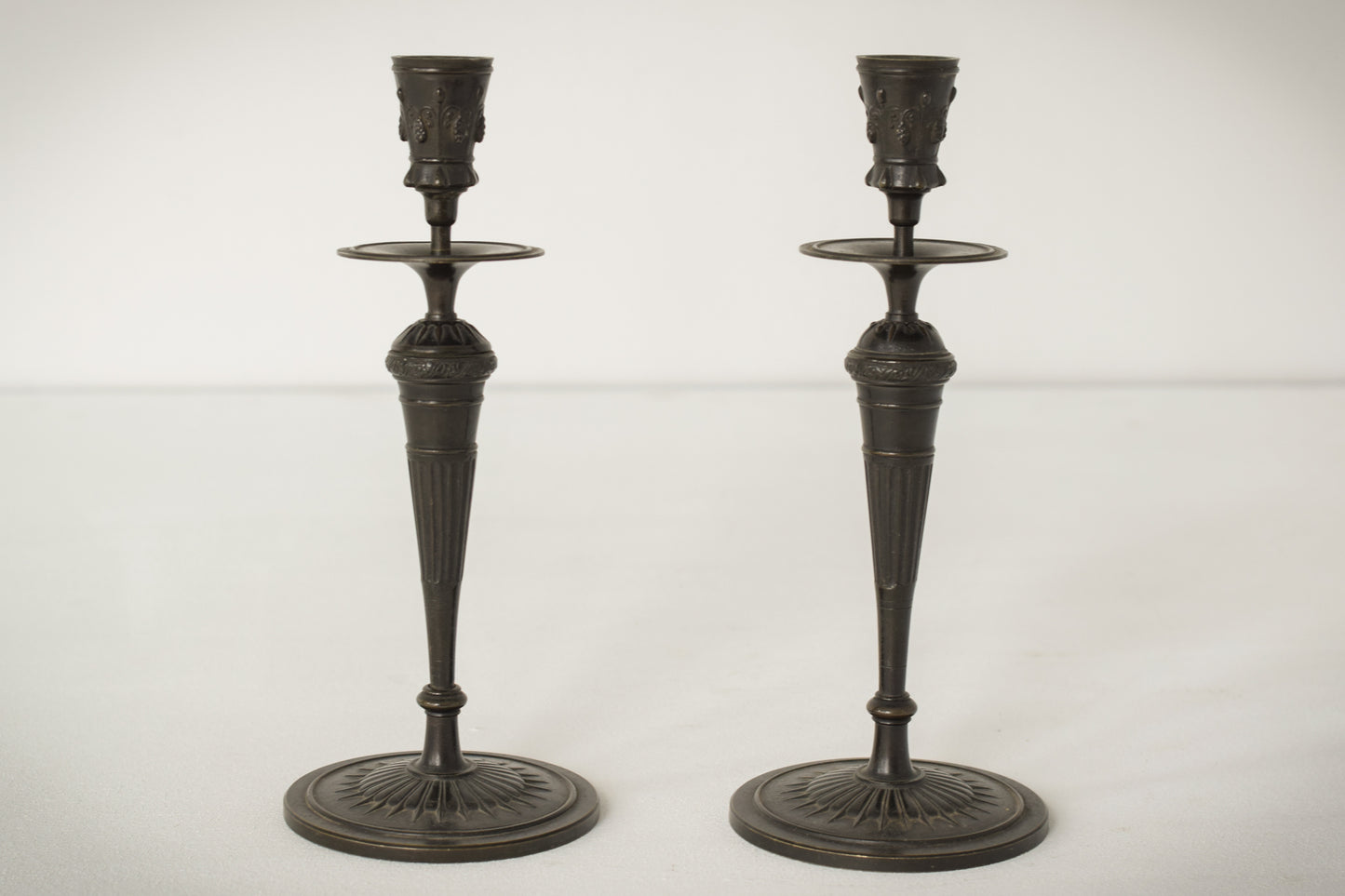 A Classic Pair of Bronze Candlesticks