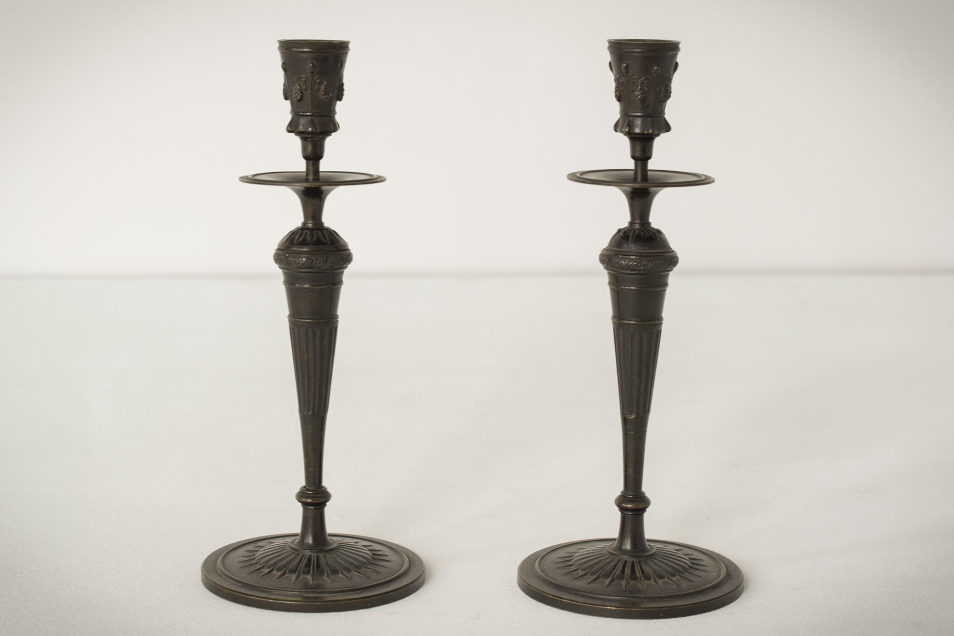 A Classic Pair of Bronze Candlesticks