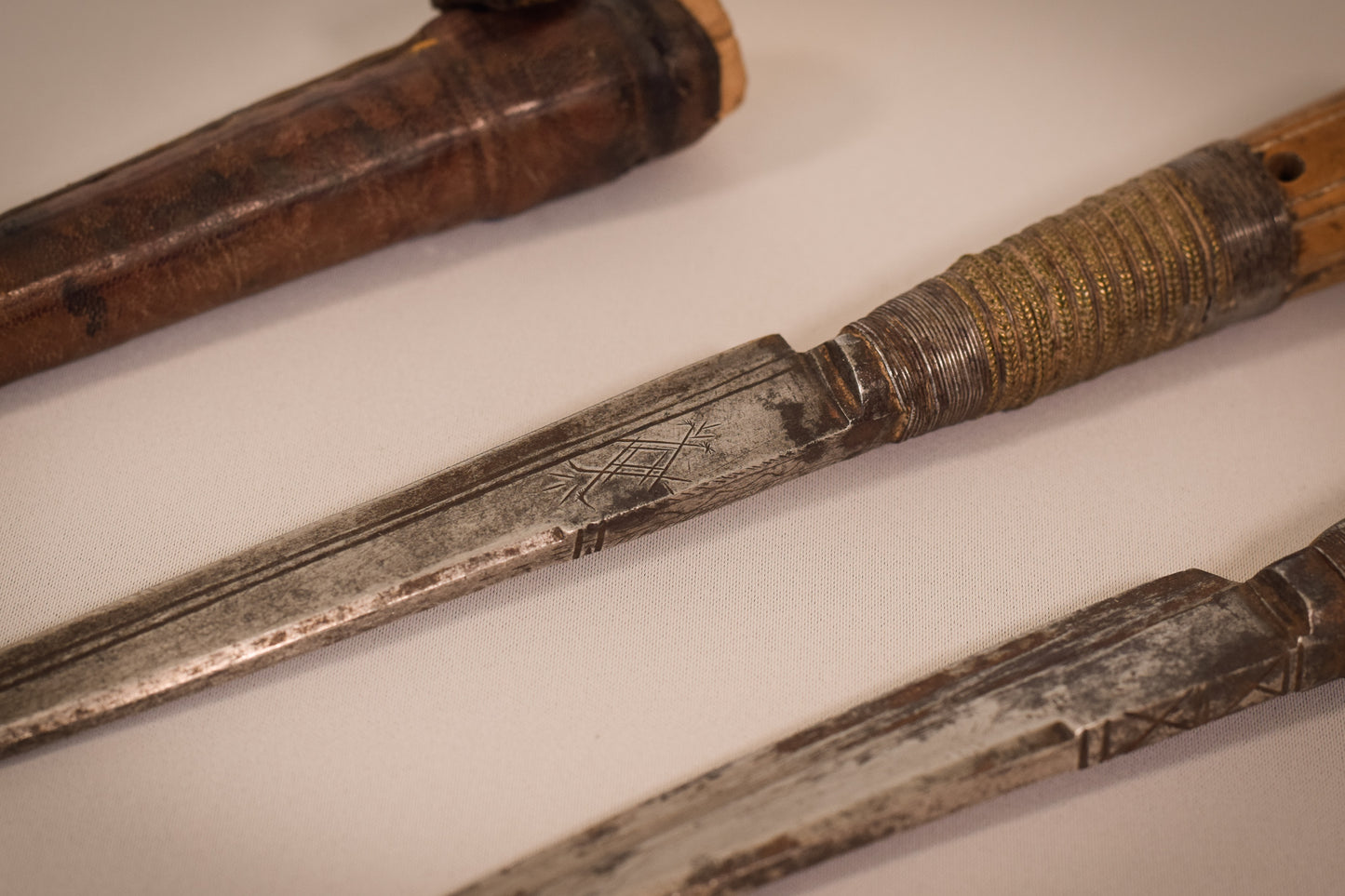Two early 17th or 18th century hunting knifes or daggers one with leather sheaf