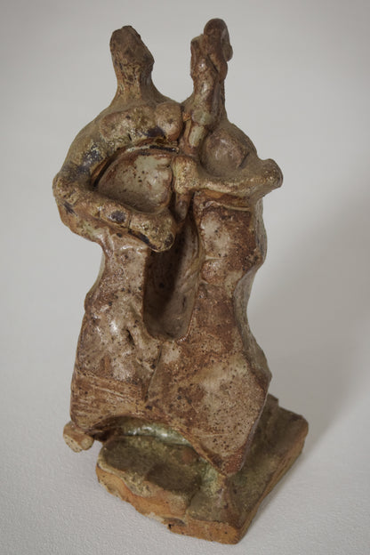 Sculpture of a Figure Playing an Instrument in an Abstract Style