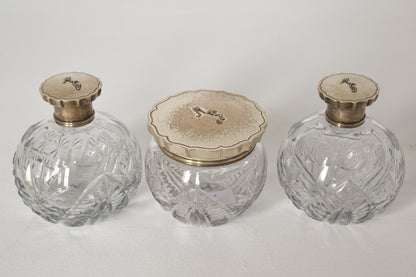 Three Silver Topped Cut Glass Bottles